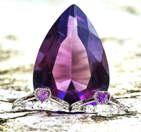 Amethyst heart crystal ring surrounded by row of cubic zirconia. Natural gemstone. Adjustable to fit all sizes.
