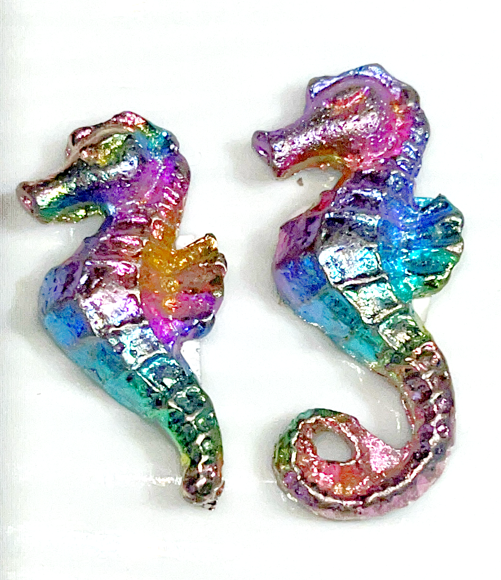 Rainbow bismuth carvings of Mermaid tails, butterflies, Mickey Mouse, Seahorses, and a froggie