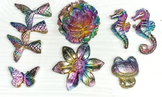 Rainbow bismuth carvings of Mermaid tails, butterflies, Mickey Mouse, Seahorses, and a froggie