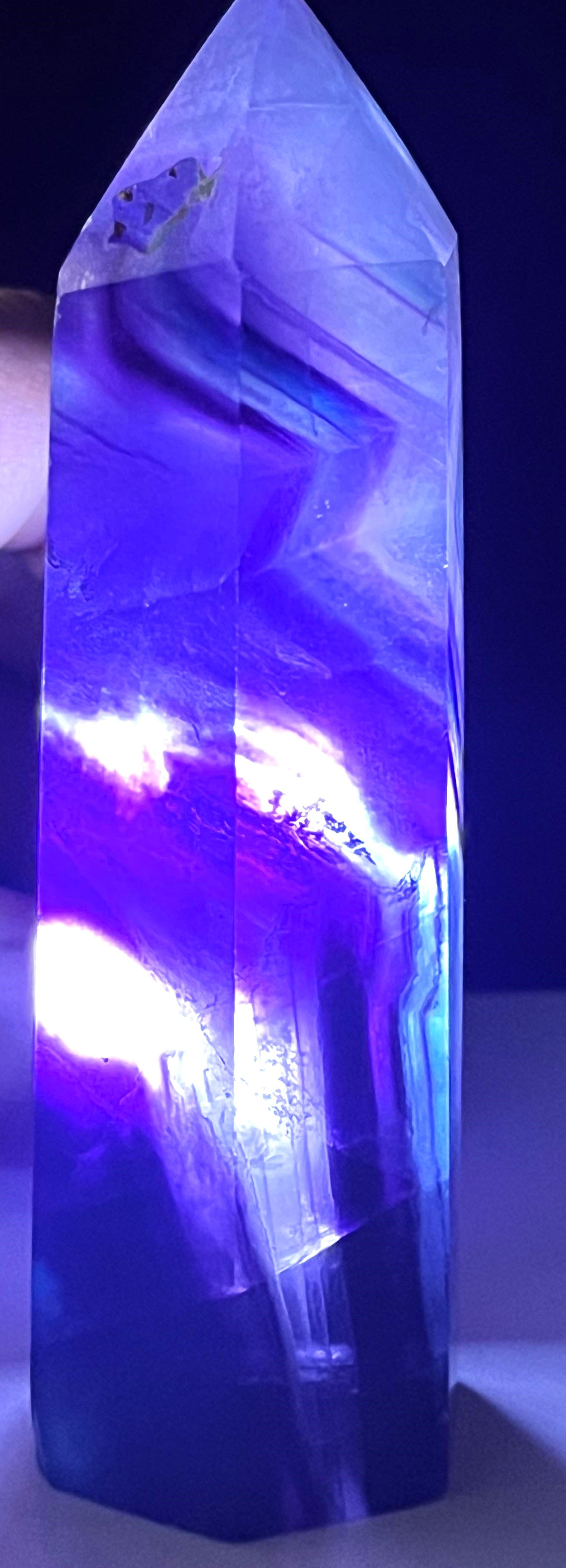 Rainbow Fluorite crystal point with beautiful purple and blue hues. Brings focus, clears mind, enhance intuition, and promote mental clarity