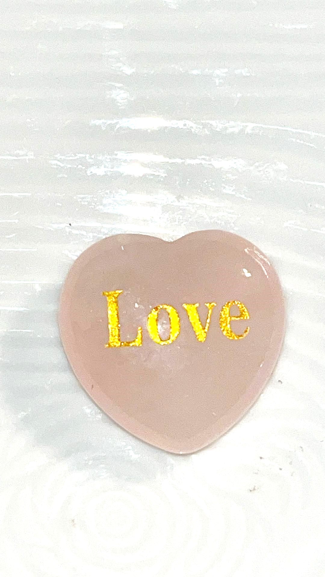 Rose Quartz LOVE Crystal hearts adorned with the word "love" inscribed in elegant gold letters.  1x1 in