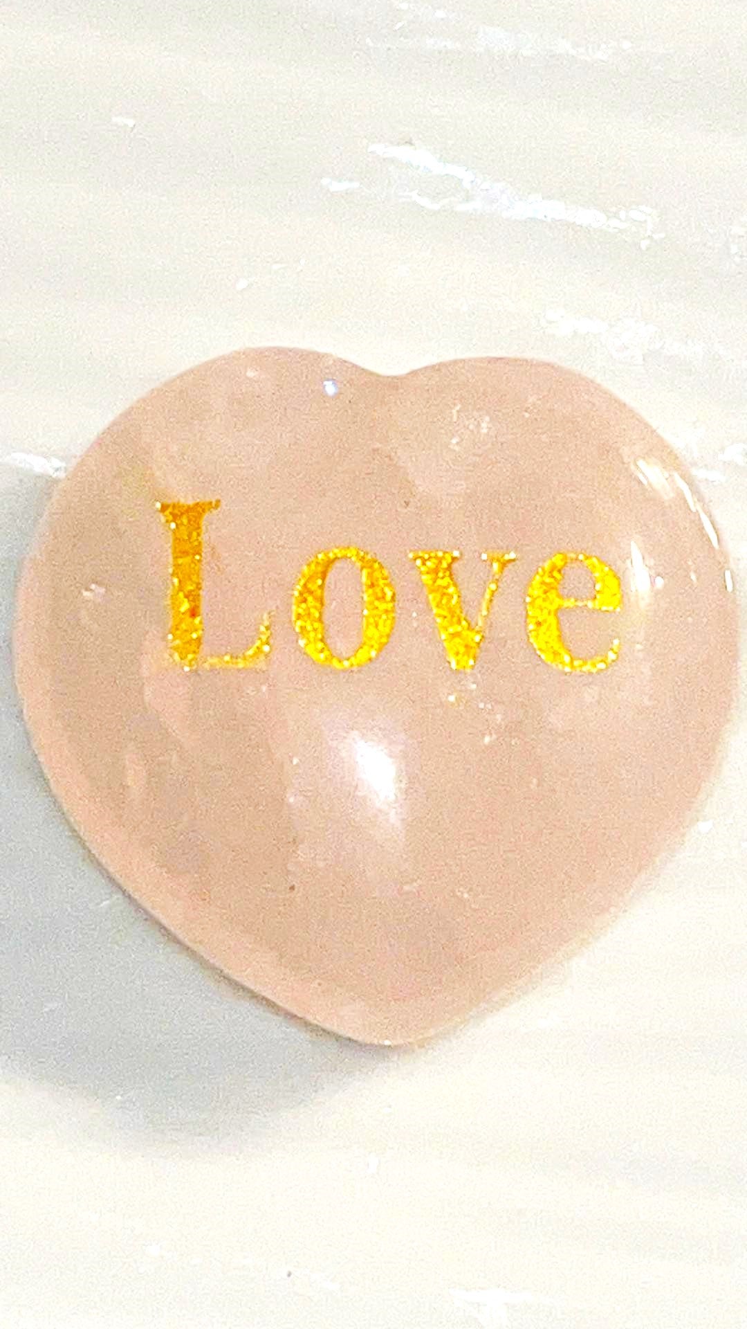 Rose Quartz LOVE Crystal hearts adorned with the word "love" inscribed in elegant gold letters.  1x1 in