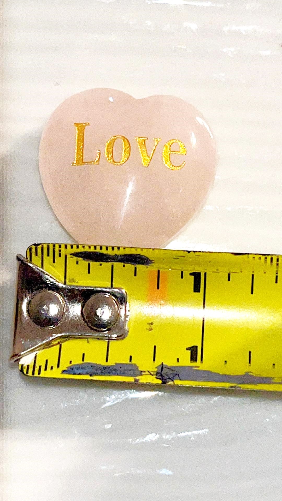 Rose Quartz LOVE Crystal hearts adorned with the word "love" inscribed in elegant gold letters.  1x1 in