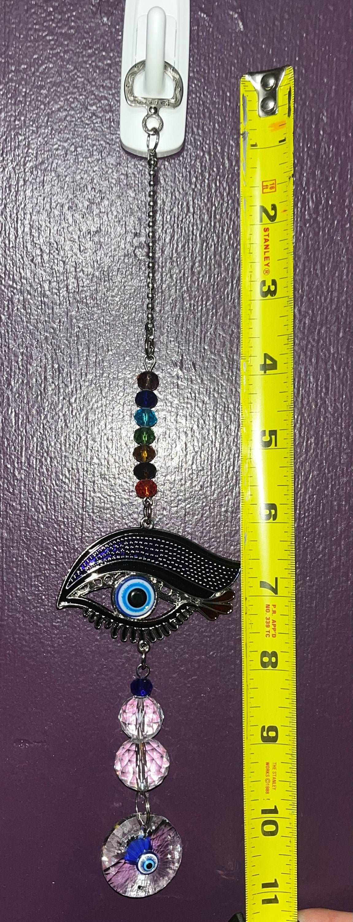 Evil eye protective sun catcher/ wall hanging with rainbow chakra beads, crystal spheres and disc.