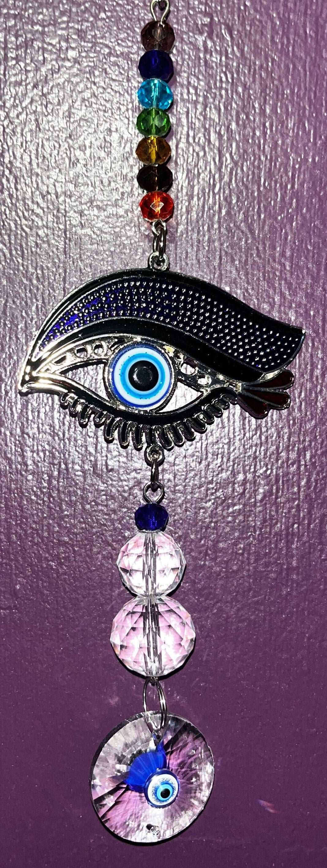 Evil eye protective sun catcher/ wall hanging with rainbow chakra beads, crystal spheres and disc.