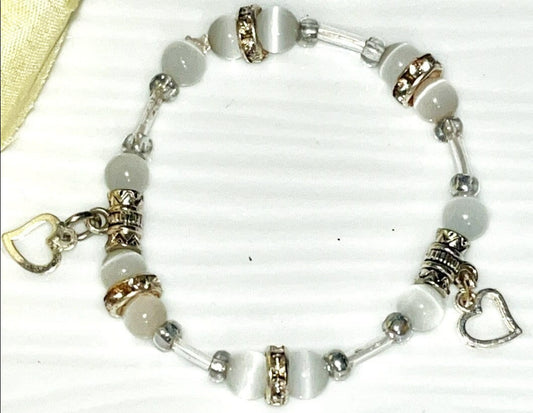 Girl's Natural Selenite crystal bead bracelet with small heart charms. All purpose spiritual cleanser and brings peace and clarity