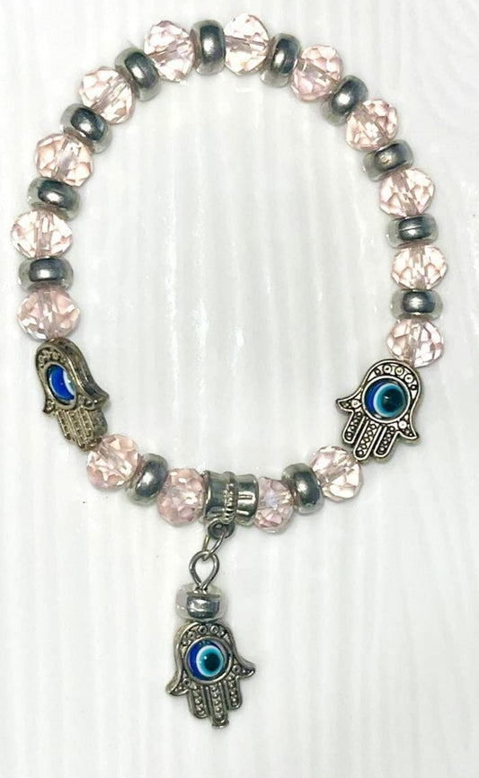 Evil Eye Bracelet with pink beads and protective blue evil eye bead charms to block negativity and evil. Protection, safety