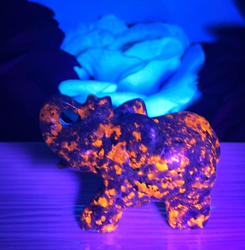 Yooperlite UV reactive glow in the dark elephant with raised trunk. Glows orange under UV light. Halloween Gothic. Trunk up= Prosperity